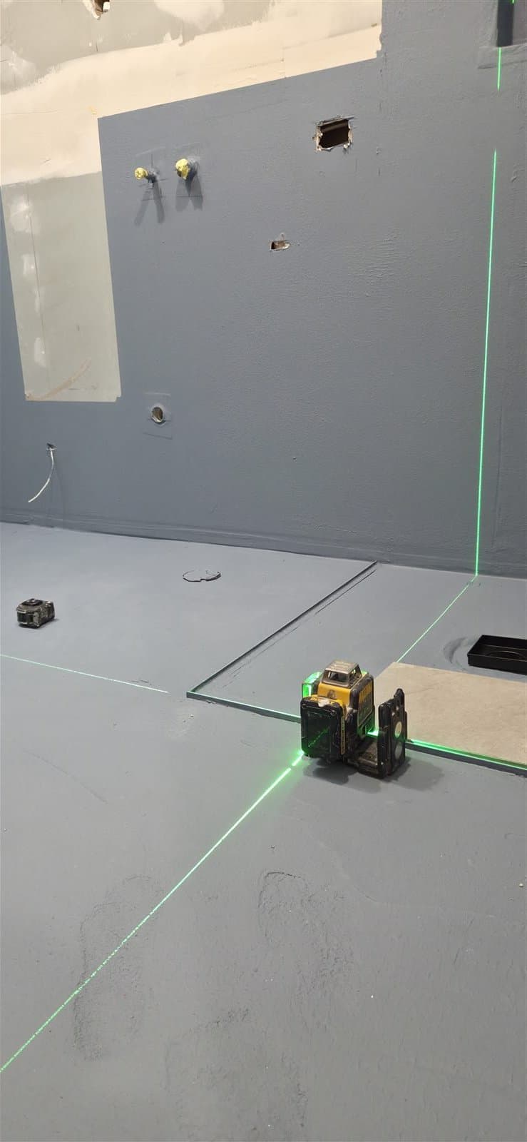 Bathroom waterproofing and laser set-out before tiling