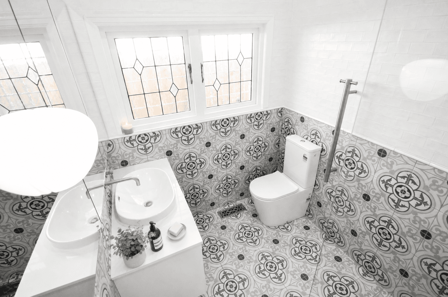 Malvern East ensuite overview with patterned floor tile, glass shower, vanity and toilet